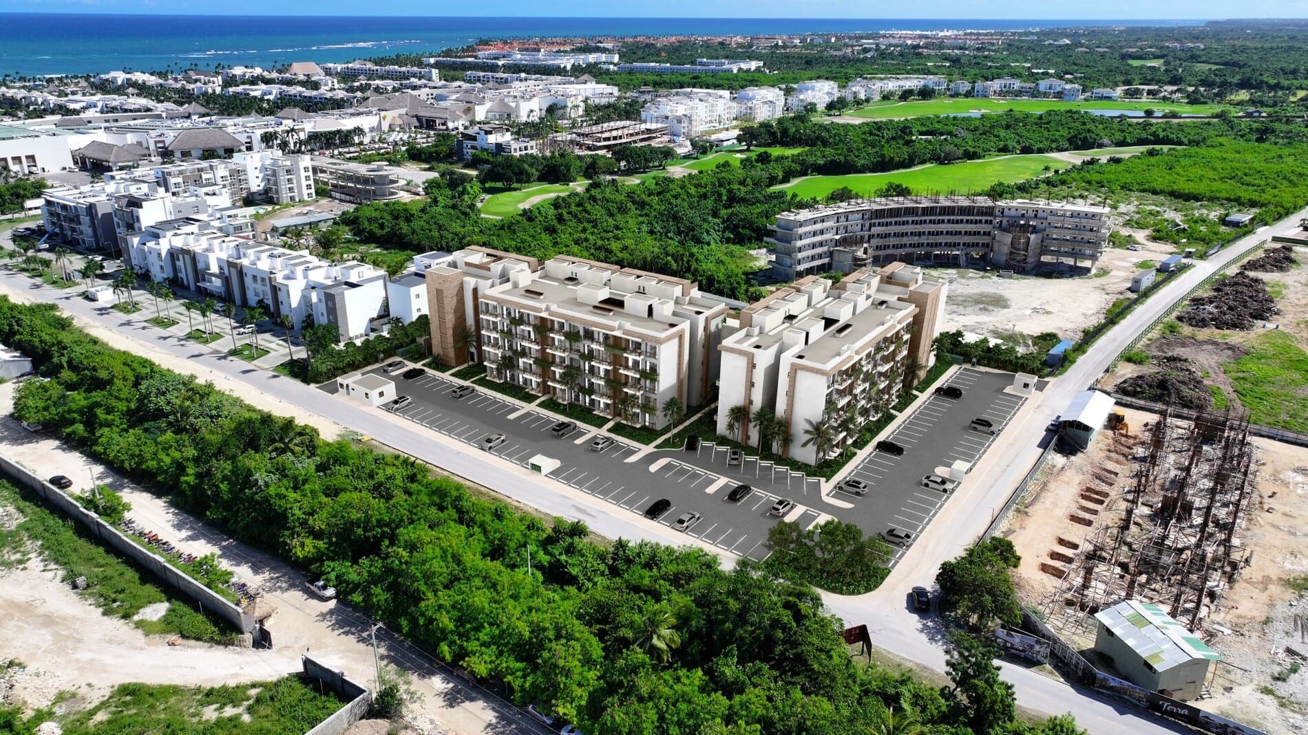 Aerial rendering of Riviera Bay at Cana Bay, the modelled blocks set over the real site with the golf course and the ocean beyond, 5 minutes from the shore.