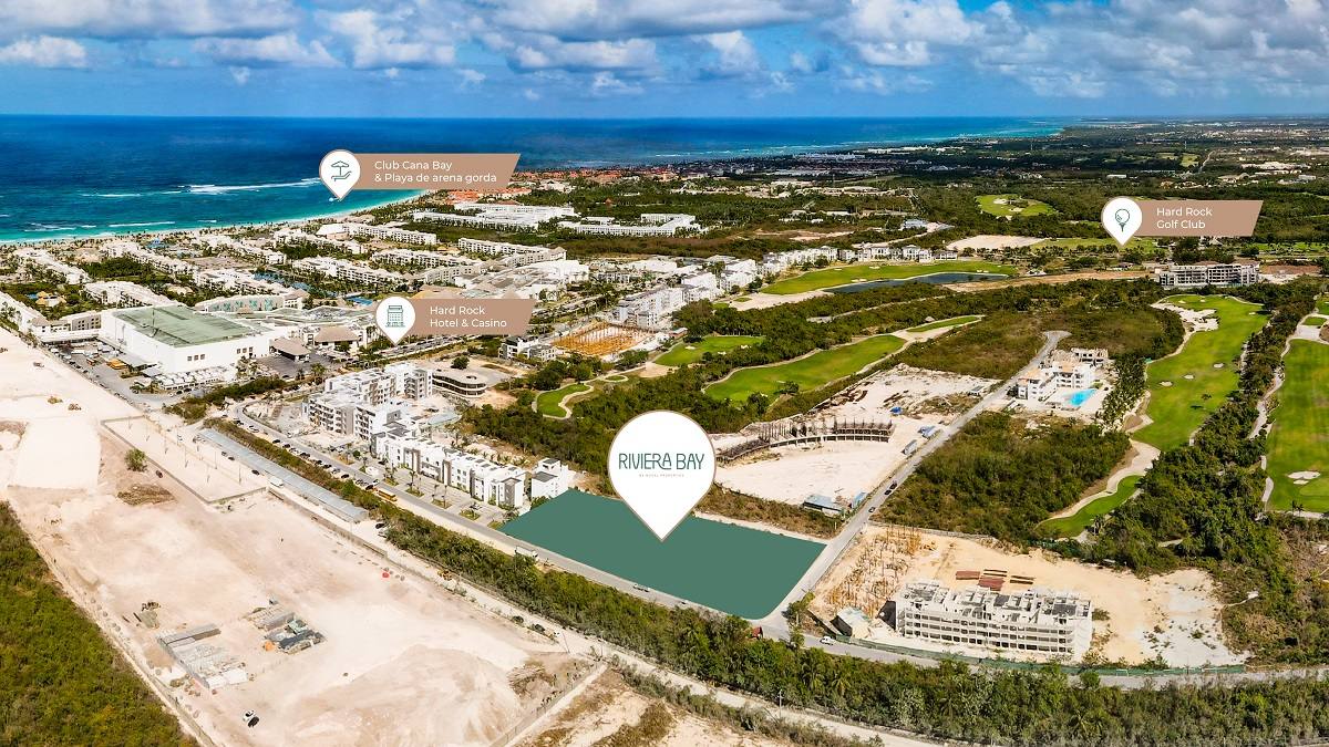Aerial photo of the gated Cana Bay golf community at Punta Cana, with the still-vacant Riviera Bay parcel marked where its 110 residences are planned.